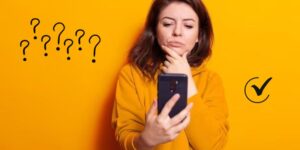 mulher com celular na mão pensando